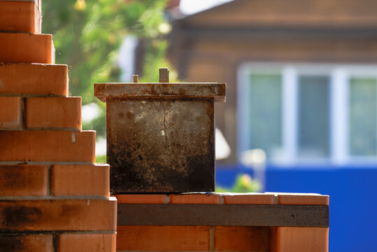 Metal smokehouse on a barbecue on a spring day