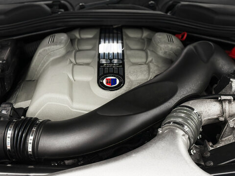 V8 engine of BMW ALPINA E63 B6 Under the bonnet sits a supercharged 4.4-litre V8, delivering 500hp, 516lb-ft of torque. Engine motor of BMW ALPINA E63, E64 B6 with emblem. BMW ALPINA E63, E64. 