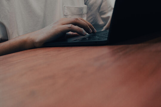 Hand Typing on Laptop Trackpad on Wooden Table, Remote Work and Technology Lifestyle Concept