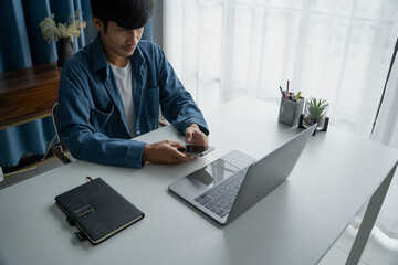 Fototapeta premium Man Typing on Laptop for Business and Tech Innovation
