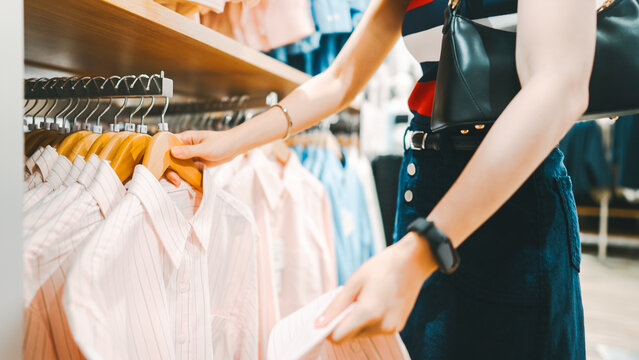 Asian woman shopping clothes in fashion shoping mall