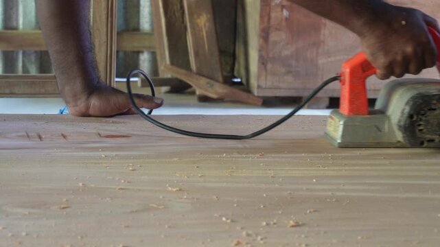 Electric woodworking planer shaping timber with precision