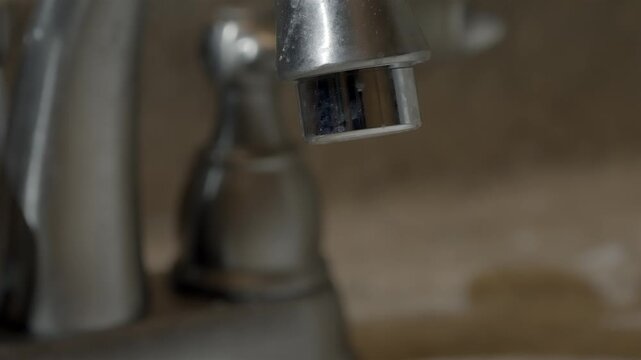 Maintenance needed for a dirty and old bathroom water facet close up