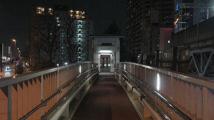 Pedestrian overpass bridge and elevator at night in Japanese city urban area © Joshua