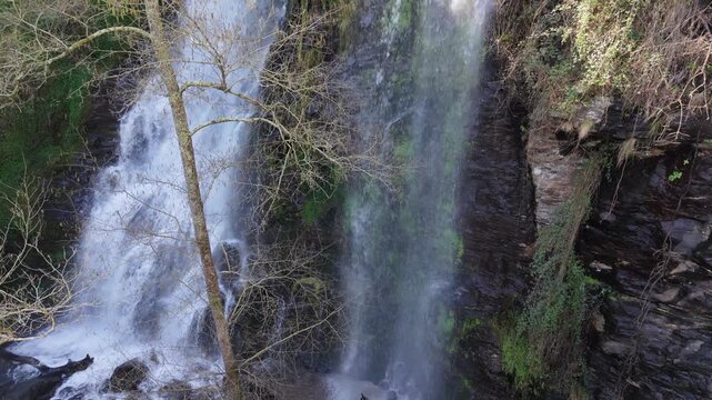 Flowing Cascades From Sheer Cliffs At Fervenza das Hortas Waterfall In Galicia, Spain. Aerial Slow Motion Shot