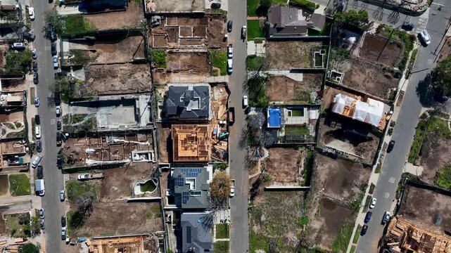 Vacant Property Lots And New Houses Being Built On Land Destroyed By The Palisades Fire In California, USA. Sliding Aerial Flyover