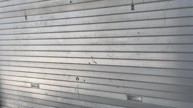 Dramatic light and shadow on metal rolling door