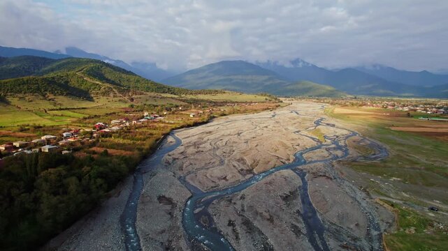 Drone Scenic Landscape. Serene Mountain River From Above. Quiet Aerial View Of Turquoise River Valleys. Peaceful Drone Footage Capturing Mountains And Flowing Waters