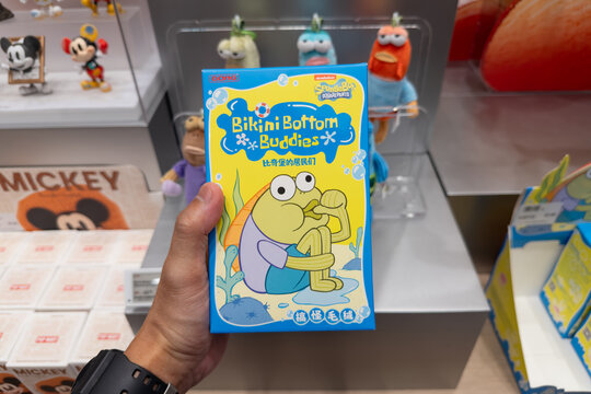 PENANG, MALAYSIA - FEB 09, 2026: Hand holding a SpongeBob SquarePants "Bikini Bottom Buddies" blind box toy package in a retail store.