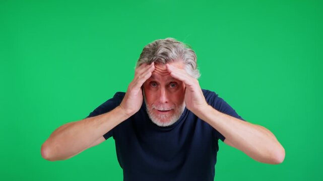 Senior man being surprised on green screen background