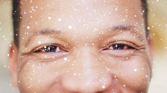 Man smiling at camera, particle overlay activating and increasing across face for marketing effect