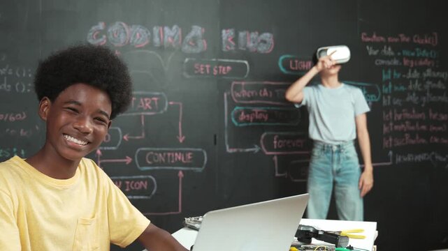 Smart african student programming and coding innovative system while caucasian girl enter in metaverse or virtual world by using VR or head set at blackboard in STEM technology classroom. Edification