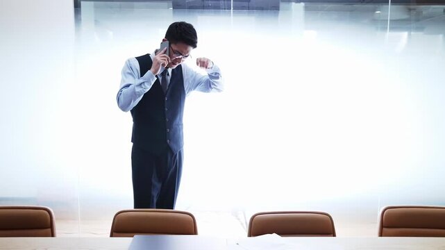 Office worker businessman feeling stressed depressed, holding painful head down, energy depletion exhaustion suffer headache while using cellphone mobile phone for talking with client business partner