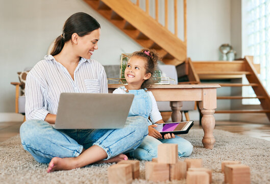 Multitasking, remote work or technology with mom and daughter in home for bonding or growth. Freelance, single parent and smile with girl child on floor with building blocks for education or learning
