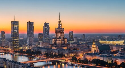 Obraz premium Illuminated city skyline at dusk with river, bridge, and stadium