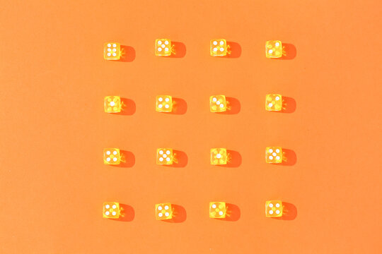 Yellow game dices on orange background