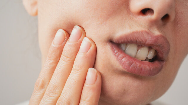 Young woman suffering from toothache