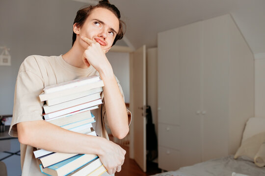 Student carrying textbooks looking dreaming about future success