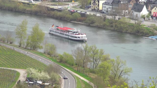 Aerial shot of a river boat cruising in Rhine river near Cochem, Germany