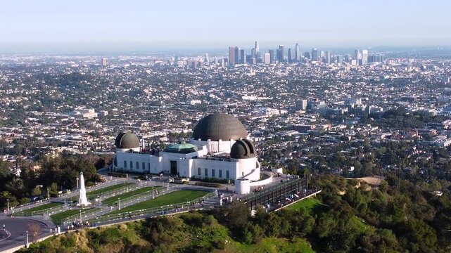 Griffith Observatory overlooking downtown Los Angeles California. City Horizon on a clear sunny day. Fenced off lawn with no people on perfect grass.
