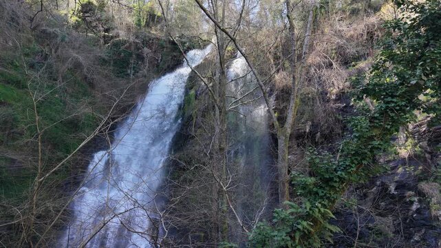 Cascades From Steep Mountains At Fervenza das Hortas Waterfall In The Galicia Region Of Spain. Low Angle Shot