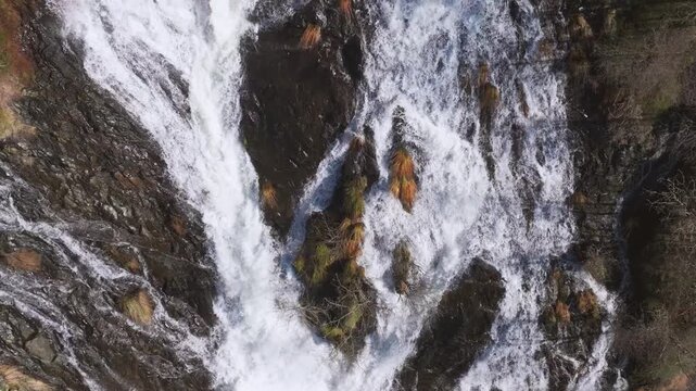 Flowing Waters Over Rugged Mountains At Fervenza das Bra&ntilde;as In Toques, Spain. Aerial Slow Motion Shot