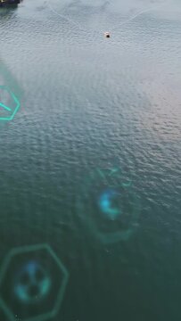 Vertical video: Pullback revealing hex holograms drifting while boat leaving wake, mapping power