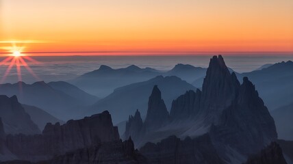 Fototapeta premium Dramatic mountain peaks at sunrise with orange sky and haze mountain range mountains landscape silhouette altitude atmosphere adventure exploration majestic serenity formation gradient