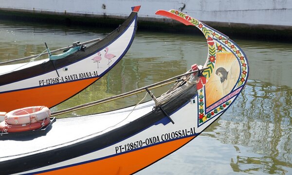 Traditional Moliceiro boats displaying colorful artwork in Aveiro Portugal. Aveiro - Portugal