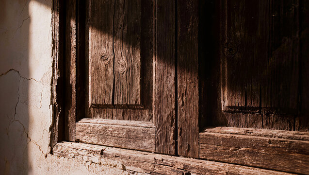 Sunlight on Grungy Wooden Window Shutter and Ancient Wall