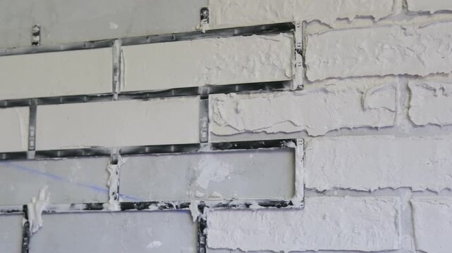 male hands making bricks using a stencil