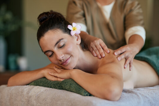 Woman relaxing at luxury spa during back massage