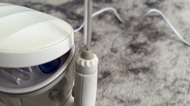 oral irrigator water flosser in close up on bathroom countertop, dental hygiene and personal care device concept