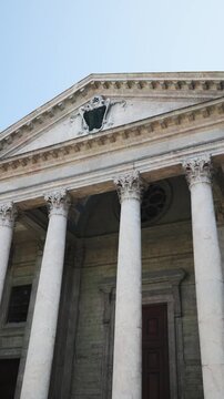 GENEVA, SWITZERLAND - MARCH 19, 2026: Vertical low angle shot of St Pierre Cathedral neoclassic columns facade