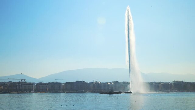 GENEVA, SWITZERLAND - MARCH 19, 2026: Static shot of Jet d'Eau water fountain towering over Lake Geneva