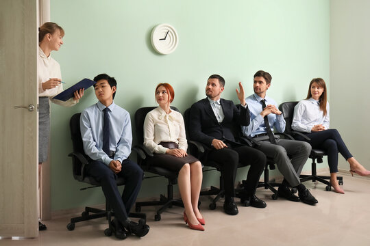 Human resources manager with applicants in room