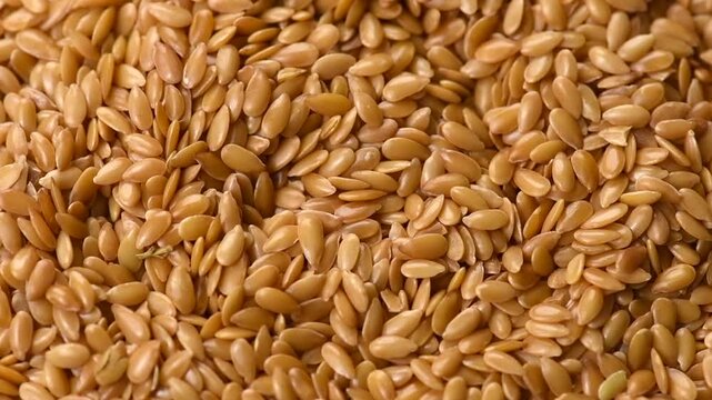 Linen seeds, Linseed. Flaxseed Background, closeup. Flax seeds, Linen seed. Healthy vegan food backdrop rotating, diet. Top view, flat lay. 