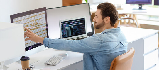 Male programmer at workplace in office
