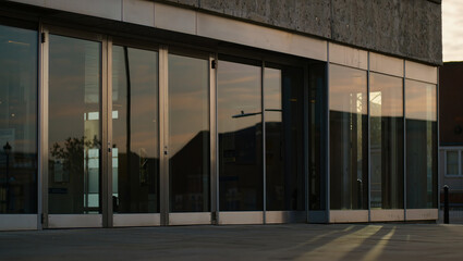 Fototapeta premium Modern Glass Building Facade at Sunset