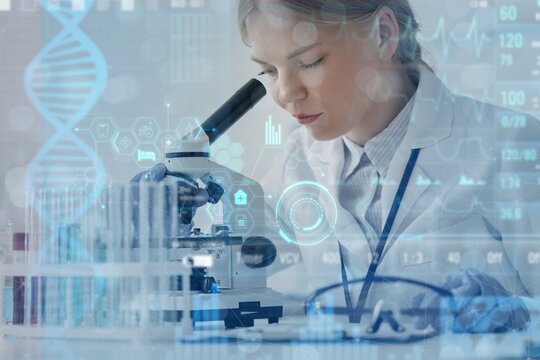 Female scientist looking through microscope in laboratory. DNA research technology