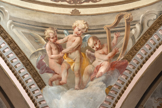 CREMA, ITALY - MARCH 20, 2026: The fresco of baroque angels with the symbols of David the church Santuario di Santa Maria della Croce by brothers Giuseppe and Giovanni Antonio Torricell from year 1762