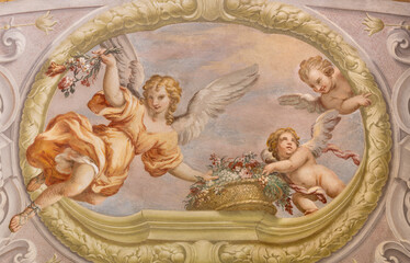 Obraz premium CREMA, ITALY - MARCH 20, 2026: The fresco of angels with the flowers the church Santuario di Santa Maria della Croce by Giacomo Parravicino - il Gianolo (1702).