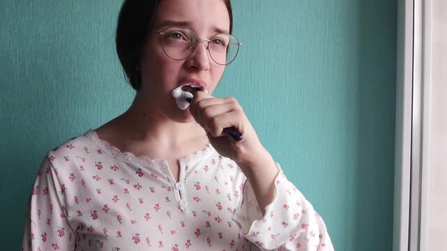 Teen girl brushing teeth in bathroom, daily hygiene routine, healthy smile and oral care concept.