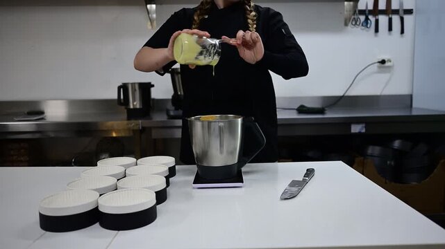 Pastry chef pouring creamy egg mixture into a blender