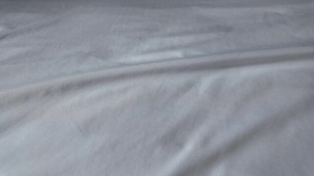 Smooth White Fabric Soft, Clean Texture with Subtle Wrinkles for Serene Bedding and Inviting Surfaces