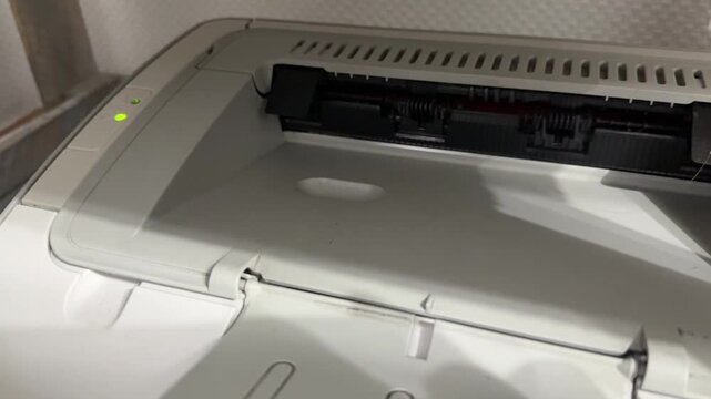printer top output area with internal rollers in close up, office printing equipment detail