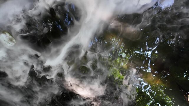 Mesmerizing Swirling Mist and Water Reflections Create Ethereal Atmosphere of Tranquility and Serenity, Captivating Senses with Natures Beauty.