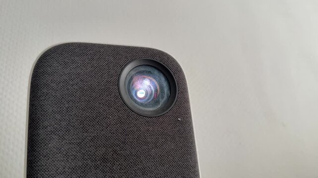 portable mini projector lens in close up, home entertainment