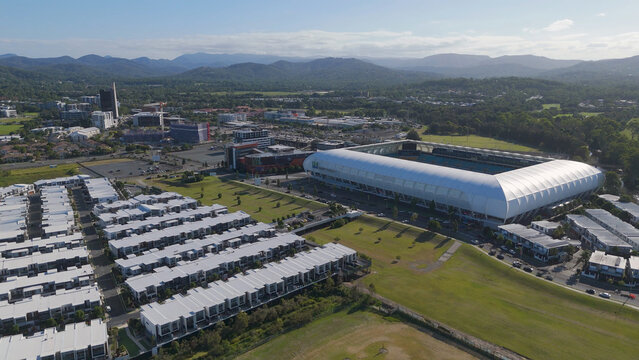 Aerial View of Large Sports Stadium and Modern Residential Housing