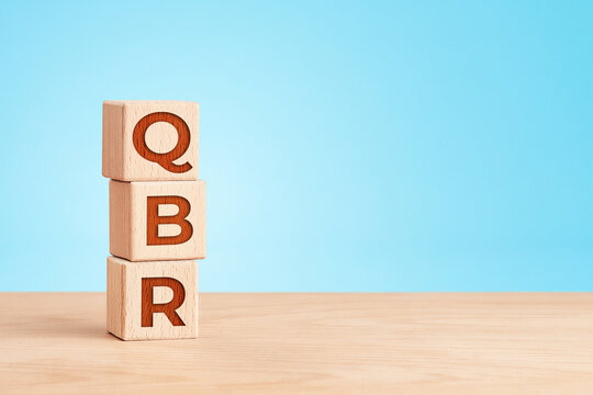 Quarterly business review concept with wooden cubes on blue